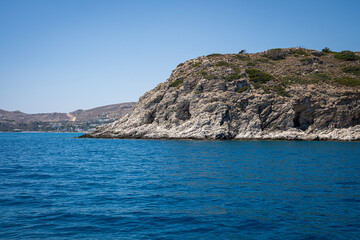 Majestic Rock Formations of Rhodes: A sea-level view of the stunning cliffs and geological wonders along the island's coastline, where the Mediterranean's blue embraces Grecian landscapes.