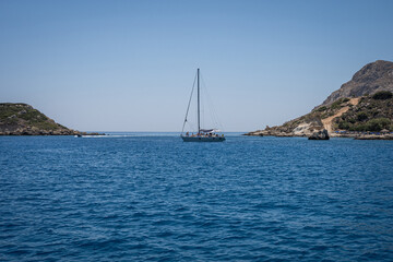 Majestic Rock Formations of Rhodes: A sea-level view of the stunning cliffs and geological wonders along the island's coastline, where the Mediterranean's blue embraces Grecian landscapes.