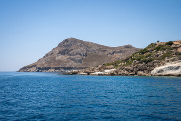 Majestic Rock Formations of Rhodes: A sea-level view of the stunning cliffs and geological wonders along the island's coastline, where the Mediterranean's blue embraces Grecian landscapes.