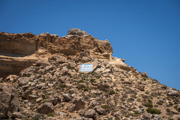 Majestic Rock Formations of Rhodes: A sea-level view of the stunning cliffs and geological wonders along the island's coastline, where the Mediterranean's blue embraces Grecian landscapes.