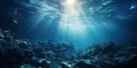 Dark blue water of a deep ocean with sun rays reaching the rocky seabed. Beautiful underwater landscape. - obrazy, fototapety, plakaty