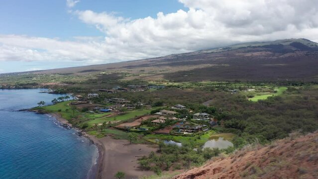 Low aerial shot flying over scenic Maluaka Beach, home of Turtle Town, along the southern coast of Maui in Hawai'i. 4K