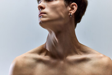 Close up cropped portrait of young male body. Naked shoulders, neck, collarbones, bust of man....
