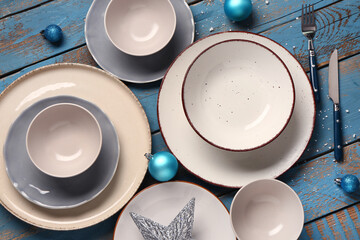 Beautiful table setting with Christmas decorations on blue wooden background