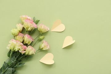 Roses with paper hearts on green background. Sweetest Day celebration
