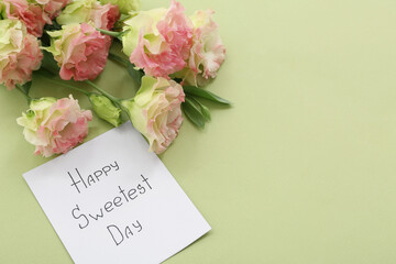 Card with text HAPPY SWEETEST DAY and roses on green background, closeup