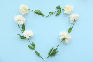 Heart made of flowers on blue background. Sweetest Day celebration
