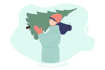Smiling woman carrying a Christmas tree