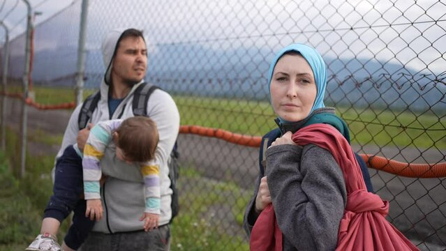 family of illegal immigrants stand at the fence the problem of undocumented persons