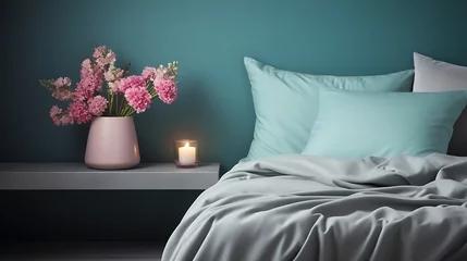 Foto auf Acrylglas Stylish modern cosy bedroom in dark colors. Cozy interior with turquoise walls, home decor. Bed with grey fabric headboard, white blanket, bedside table, vase with pink hydrangea flower, candle © Alin