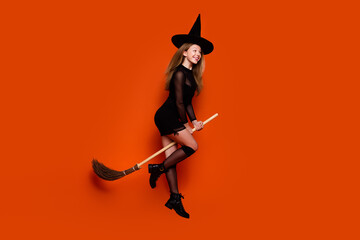 Full body photo of attractive blonde teen woman broom flying sabbath dressed black halloween...