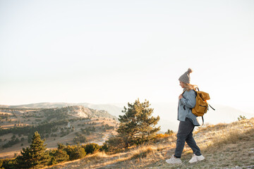 The plus size woman walks in the mountain. The gil admires beautiful views of landscape. Travel and...