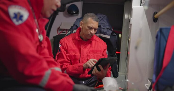 Talking, man and a tablet at sea for rescue team, communication and emergency at sea. Teamwork, digital and a medical employee working on a boat with tchnology for service, analysis or research