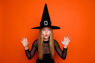 Portrait of terrifying mysterious enchant magician girl arms scare boo isolated on orange color background