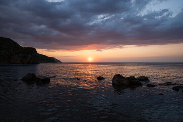 Fototapeta premium Sunset by the sea. Sunset long exposure. Sunset from the beach. Sea cliffs and sunset. Galippoli, Canakkale, Türkiye.