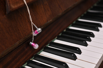 piano keyboard with headphones. music concept banner.