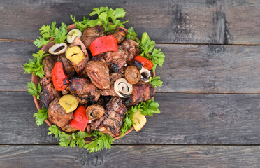 Barbecue of pork ribs and vegetables in a plate.