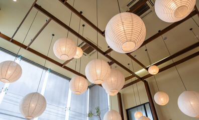 Modern ceiling lamp applied from bamboo and mulberry paper Japan style interior lighting bulbs decoration contemporary. Japanese Lantern at restaurant. Selective Focus
