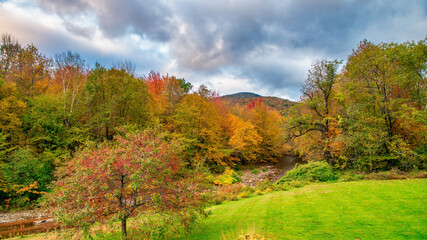 Fototapeta na wymiar Autumn foliage in fall season. Red autumn landscapes in fall, trees and mountains of New England