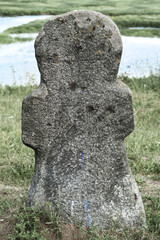 Stone idol against the background of the river.