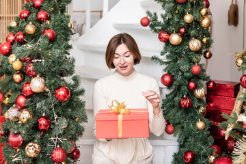 Happy girl opening a Christmas present