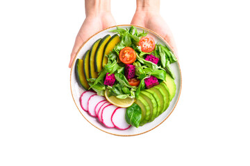 Vegan salad with vegetables and fruits on plate holding by hand, Healthy food