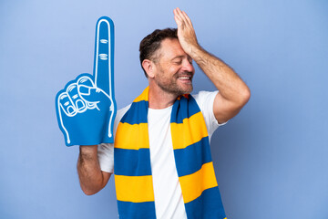 Middle age caucasian sports fan man isolated on blue background has realized something and...