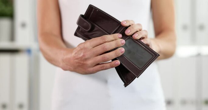 Woman holding and shaking empty leather wallet 4k movie. Economic crisis concept