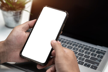 Man holding smartphone with blank screen, close-up of hands. Space for text.
