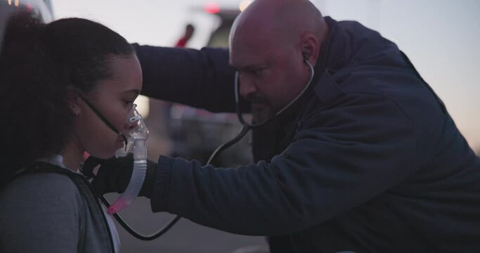 Paramedic, woman and oxygen mask with stethoscope for emergency, accident or crime scene with injury, danger or support. Anesthesia, girl or first responder with medical care, ventilation or check