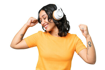 Young caucasian Argentinian woman over isolated background listening music and dancing