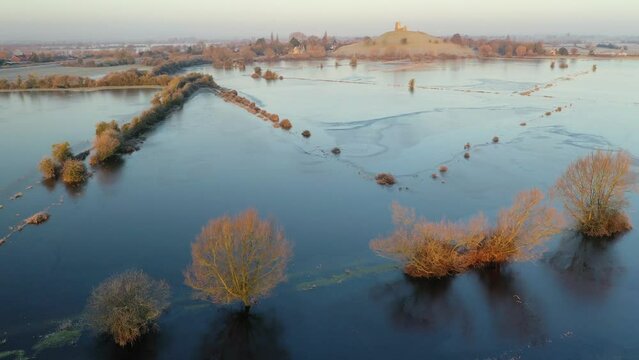 Aerial showing flooded frozen fields on the Somerset Levels near Burrow Mump, Somerset, England