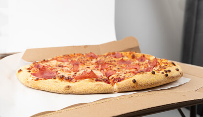 Italian Pizza in Cardboard Delivery Box, Ham Pizza with Green Hot Pepper, Chili Pepper and Mozzarella Cheese