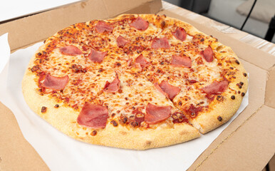 Italian Pizza in Cardboard Delivery Box, Ham Pizza with Green Hot Pepper, Chili Pepper and Mozzarella Cheese