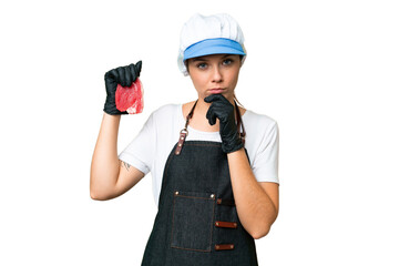 Butcher woman wearing an apron and serving fresh cut meat over isolated chroma key background thinking