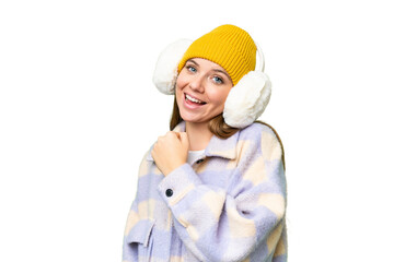 Young blonde woman wearing winter muffs over isolated chroma key background celebrating a victory
