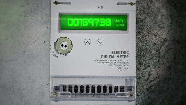 Electric digital meter mounted on the wall, showing residence energy consumption. Modern electricity meter device visualization