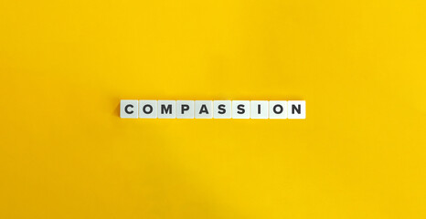 Compassion (Feeling for Another) Word and Concept Image. Letter Tiles on Yellow Background. Minimal Aesthetic.