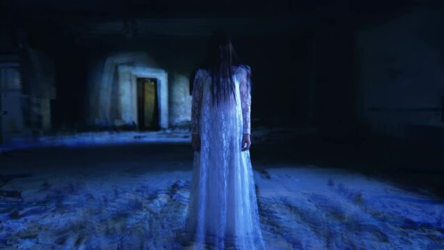 Ghost woman with long black hair materializing in an abandoned building, witch. Creepy fantom of a bride in a haunted budling