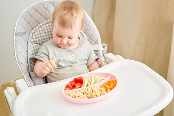 Cute child eats healthy food vegetables and meatballs from dietary meat steamed,. Portraits of a...