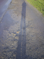 shadow of a man on earth,the shadow of a person on the dirt path