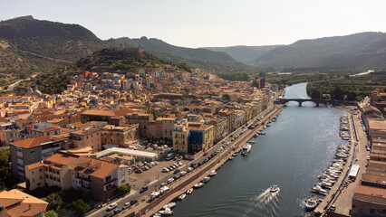 Fototapeta na wymiar Aerial view of the Temo river as it passes through the town of Bosa, a tourist destination on the island of Sardinia in Italy