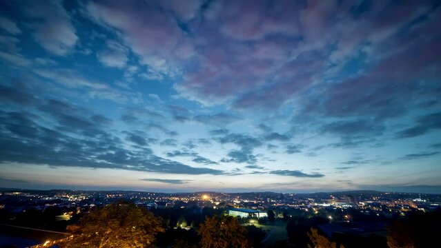night sky with clouds over a sleeping city time lapse
