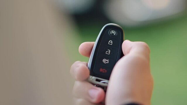 Car Remote in Hand. Unlocking a Car Remotely with Key