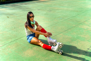 Middle-aged woman in casual clothes taking a break from roller skating