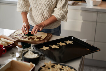 Unrecognizable woman preparing dough for gingerbread cookies