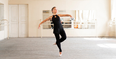 Fototapeta na wymiar professional ballerina dancer doing ballet dance moves on a master class
