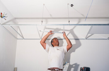 Worker plastering tool plaster marble on interior plaster rough