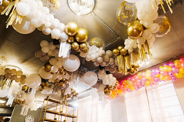 White and gold balloon decor for the holiday. 