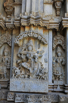 Close up of goddess Nritya Lakshmi sculpture under eves on shrine outer wall in the Chennakesava Temple, Hoysala Architecture, Somanathpur, Karnataka, India